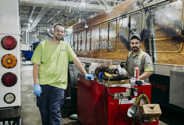 Two Mechanics Working on Buses