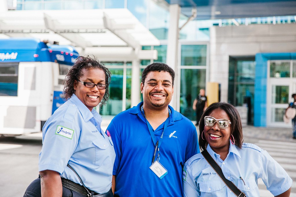 Three IndyGo employees pose outside Carson Transit Center in Indianapolis.