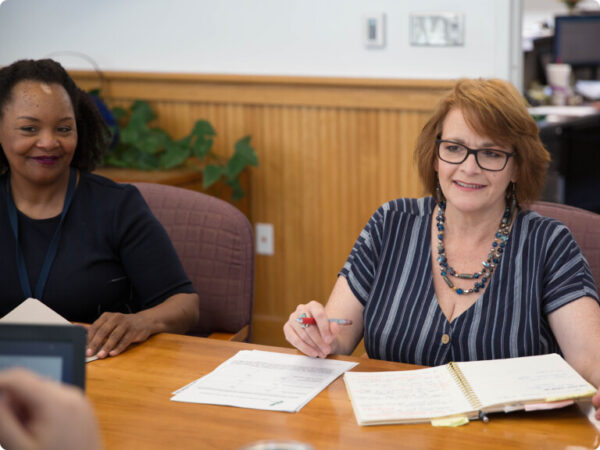 Two IndyGo Employees Around a Conference Table