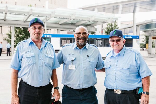Three IndyGo Coach Drivers outside of Carson Transit Center