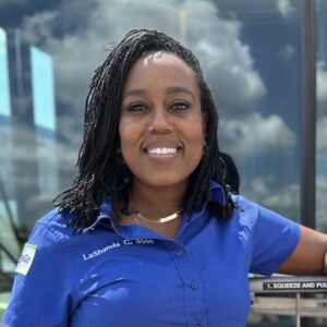 Image of LaShanda Carrol Leaning on bike rack on bus.