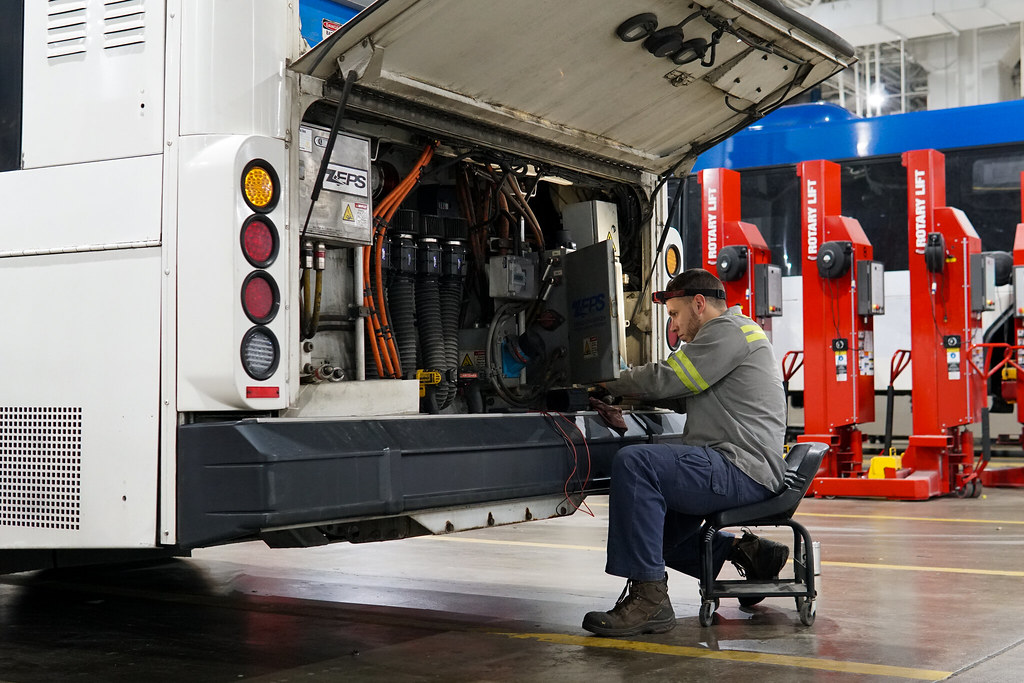 IndyGo mechanic working on bus engine